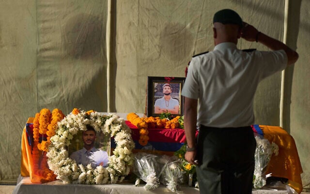 A member of the Nepalese army pays his respects to Bipin Joshi, a Nepali man who was taken hostage by Hamas, during a memorial procession at Tribhuvan International Airport in Kathmandu, Nepal, October 20, 2025. (AP/Niranjan Shrestha)