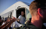 Freed hostage Avinatan Or is welcomed as he heads from the hospital to his home in the West Bank settlement of Shilo, October 21, 2025. (AP Photo/Ohad Zwigenberg)