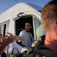 Freed hostage Avinatan Or is welcomed as he heads from the hospital to his home in the West Bank settlement of Shilo, October 21, 2025. (AP Photo/Ohad Zwigenberg)