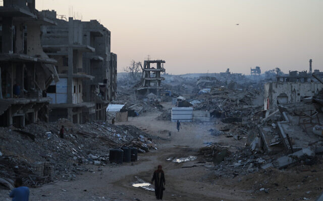 Palestinians walk through destruction in the Sheikh Radwan neighborhood in Gaza City, October 22, 2025. (AP/Abdel Kareem Hana) Palestinians walk through destruction in the Sheikh Radwan neighborhood in Gaza City, October 22, 2025. (AP/Abdel Kareem Hana)
