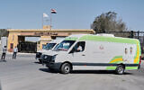 Egyptian ambulances line up as they wait for possible Palestinian arrivals at the Egyptian gate of the Rafah crossing with Gaza, following an agreement between Israel and Hamas on a ceasefire, October 22, 2025. (AP/Mohamed Arafat)