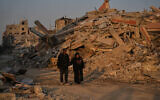 Palestinians walk through the destruction in Gaza City, October 23, 2025. (AP Photo/Abdel Kareem Hana)