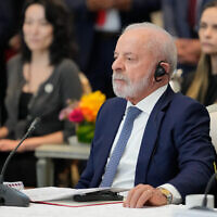 Brazilian President Luiz Inácio Lula da Silva listens to a speech by Malaysian Prime Minister Anwar Ibrahim, unseen, during a meeting in Putrajaya, Malaysia, Saturday, Oct. 25, 2025. (AP Photo/Vincent Thian, Pool)