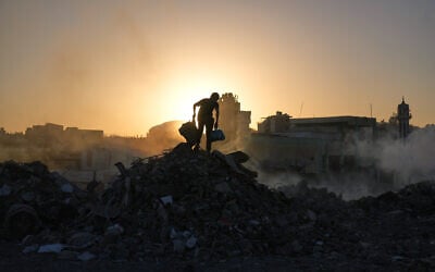 Palestinians search for firewood and plastic at a landfill in Gaza City Saturday, Oct. 25, 2025. (AP/Abdel Kareem Hana)
