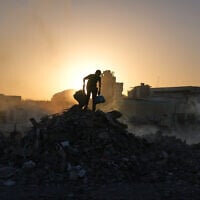 Palestinians search for goods at a landfill in Gaza City, October 25, 2025. (AP Photo/Abdel Kareem Hana)