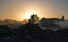 Palestinians search for goods at a landfill in Gaza City, October 25, 2025. (AP Photo/Abdel Kareem Hana)