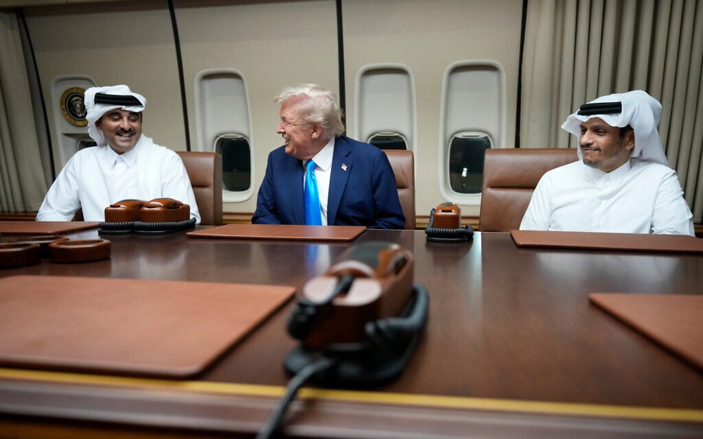 US President Donald Trump, center, meets with Emir of Qatar Sheikh Tamim bin Hamad al-Thani, left, and Qatar Prime Minister and Foreign Minister Sheikh Mohammed bin Abdulrahman bin Jassim Al Thani aboard Air Force One at Al Udeid Air Base in Doha, Qatar, October 25, 2025. (AP Photo/Mark Schiefelbein)