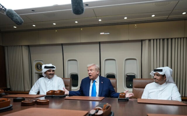 US President Donald Trump, center, meets with Emir of Qatar Sheikh Tamim bin Hamad al-Thani, left, and Qatar Prime Minister and Foreign Minister Sheikh Mohammed bin Abdulrahman bin Jassim Al Thani aboard Air Force One at Al Udeid Air Base in Doha, Qatar, October 25, 2025. (AP Photo/Mark Schiefelbein)