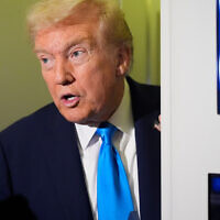 US President Donald Trump speaks with reporters aboard Air Force One at Al Udeid Air Base in Doha, Qatar, October 25, 2025. (AP Photo/Mark Schiefelbein)