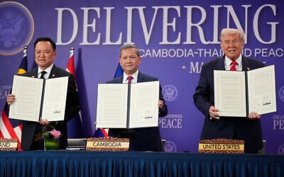 US President Donald Trump, Cambodian Prime Minister Hun Manet, left, and Thailand's Prime Minister Anutin Charnvirakul pose with their documents during a signing ceremony on the sidelines of the ASEAN Summit in Kuala Lumpur, Malaysia, October 26, 2025. (AP Photo/Mark Schiefelbein)
