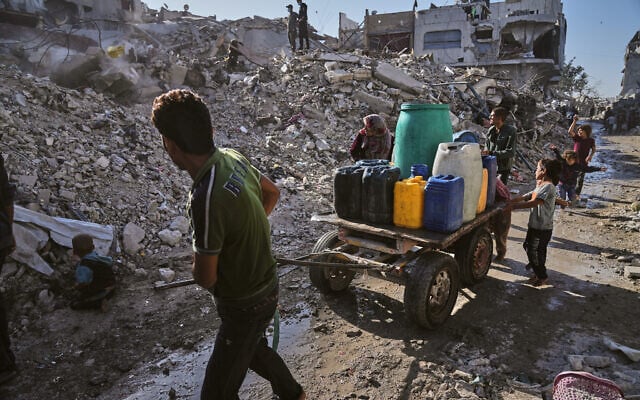Palestinians carry water amid the ruins of Gaza City, Oct. 26, 2025. (AP/Jehad Alshrafi) Palestinians carry water amid the ruins of Gaza City, Oct. 26, 2025. (AP/Jehad Alshrafi)
