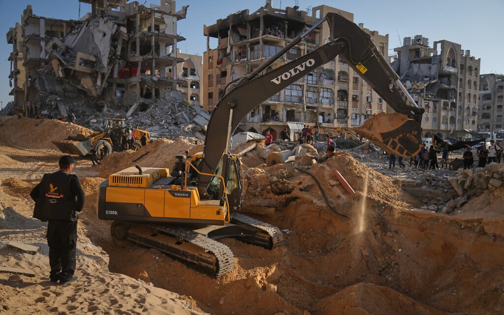 Palestinians watch machinery and some workers from Egypt searching for the bodies of hostages at Hamad City, in Khan Younis, southern Gaza Strip, Oct. 26, 2025. (AP/Jehad Alshrafi) Palestinians watch machinery and some workers from Egypt searching for the bodies of hostages at Hamad City, in Khan Younis, southern Gaza Strip, Oct. 26, 2025. (AP/Jehad Alshrafi)