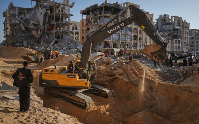 Palestinians watch machinery and some workers from Egypt searching for the bodies of hostages at Hamad City, in Khan Younis, southern Gaza Strip, Oct. 26, 2025. (AP/Jehad Alshrafi) Palestinians watch machinery and some workers from Egypt searching for the bodies of hostages at Hamad City, in Khan Younis, southern Gaza Strip, Oct. 26, 2025. (AP/Jehad Alshrafi)