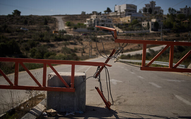A gate set up by Israeli authorities blocks one of the entrances to the West Bank village of Atara, on September 30, 2025. (AP Photo/Leo Correa)