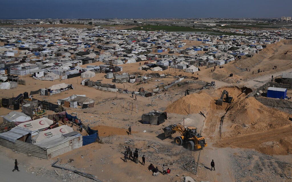 Egyptian machinery and workers search for the bodies of hostages near a tent camp for displaced Palestinians in Hamad City, Khan Younis, in the southern Gaza Strip, Oct. 28, 2025. (AP Photo/Abdel Kareem Hana)
