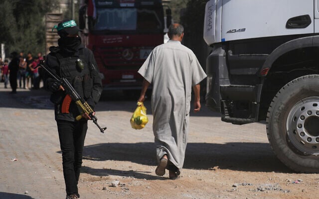 Members of the al-Qassam Brigades, the military wing of Hamas, stand at the site where they, along with Egyptian workers and machinery, claim to be searching for the bodies of hostages in Nuseirat, Gaza Strip, October 28, 2025. (AP Photo/Abdel Kareem Hana) Members of the al-Qassam Brigades, the military wing of Hamas, stand at the site where they, along with Egyptian workers and machinery, claim to be searching for the bodies of hostages in Nuseirat, Gaza Strip, October 28, 2025. (AP Photo/Abdel Kareem Hana)