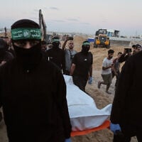 Illustrative image: Hamas terrorists carry a white bag believed to contain a body, after retrieving it from a tunnel during a search for the remains of hostages in Hamad City, Khan Younis, in southern Gaza, October 28, 2025. (AP Photo/Jehad Alshrafi)