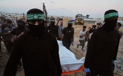 Illustrative image: Hamas terrorists carry a white bag believed to contain a body, after retrieving it from a tunnel during a search for the remains of hostages in Hamad City, Khan Younis, in southern Gaza, October 28, 2025. (AP Photo/Jehad Alshrafi)