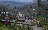 Residents walk through Lacovia Tombstone, Jamaica, in the aftermath of Hurricane Melissa, October 29, 2025. (AP Photo/Matias Delacroix)