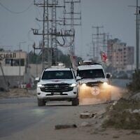 Red Cross vehicles carrying the bodies of two people believed to be deceased hostages handed over by Hamas make their way toward the Kissufim border crossing with Israel, to be transferred to Israeli authorities, in Deir al-Balah, central Gaza Strip, October 30, 2025. (AP Photo/Abdel Kareem Hana)