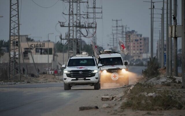 Red Cross vehicles carrying the bodies of two people believed to be deceased hostages handed over by Hamas make their way toward the Kissufim border crossing with Israel, to be transferred to Israeli authorities, in Deir al-Balah, central Gaza Strip, October 30, 2025. (AP Photo/Abdel Kareem Hana)