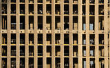 Ultra-Orthodox Jewish men stand on multiple floors of a building under construction and watch a protest against service in the Israeli military, in Jerusalem, Thursday, Oct. 30, 2025. (AP Photo/Ohad Zwigenberg)