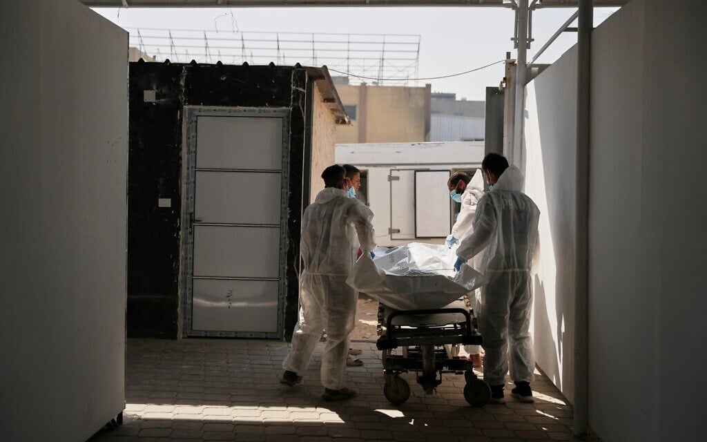 Bodies of unidentified Palestinians returned from Israel as part of the ceasefire deal are placed at a warehouse in Nasser Hospital in Khan Younis, Gaza Strip, October 31, 2025. (AP Photo/Abdel Kareem Hana)