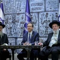 Sephardic Chief Rabbi David Yosef (right) and Ashkenazi Chief Rabbi Kalman Ber (left), with Israel's President Isaac Herzog during their swearing-in ceremony at the President Residence in Jerusalem, on November 4, 2024. (Chaim Goldberg/Flash90)
