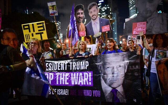 A sign urging US President Donald Trump to end the war in Gaza is hoisted during a rally demanding a ceasefire-hostage deal, outside the IDF headquarters in Tel Aviv, September 30, 2025. (Avshalom Sassoni/Flash90)