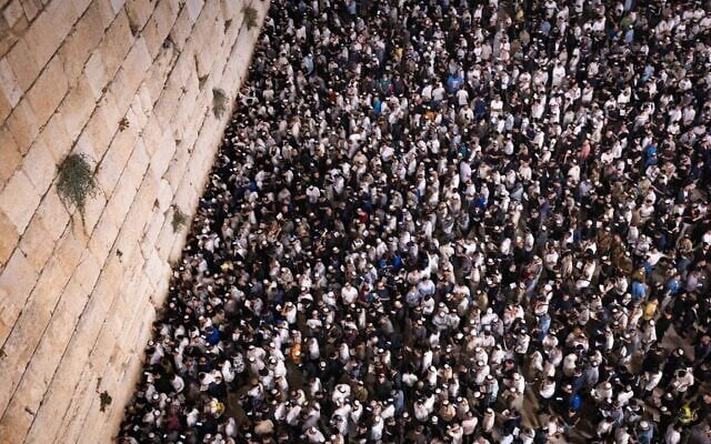 Jews praying for forgiveness (Selichot), at the Western Wall in the Old City of Jerusalem, early on October 1, 2025, on the eve of the Jewish holiday of Yom Kippur. (Chaim Goldberg/Flash90)