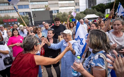 People celebrate at Hostage Square in Tel Aviv, as negotiators are set to sign a hostage-ceasefire deal. October 09, 2025. (Chaim Goldberg/FLASH90) People celebrate at Hostage Square in Tel Aviv, as negotiators are set to sign a hostage-ceasefire deal. October 09, 2025. (Chaim Goldberg/FLASH90)