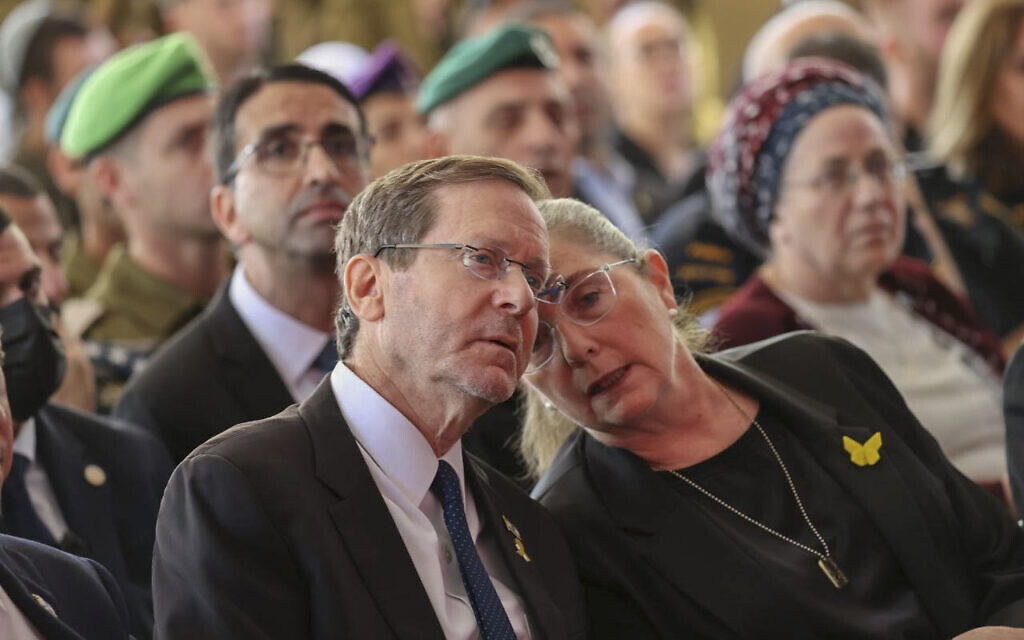 President Isaac Herzog, left, and his wife Michal attend a state ceremony marking the anniversary of the Hamas terrorist attack on October 7, at Mount Herzl military cemetery in Jerusalem, on October 16, 2025. (Alex Kolomoisky/POOL)