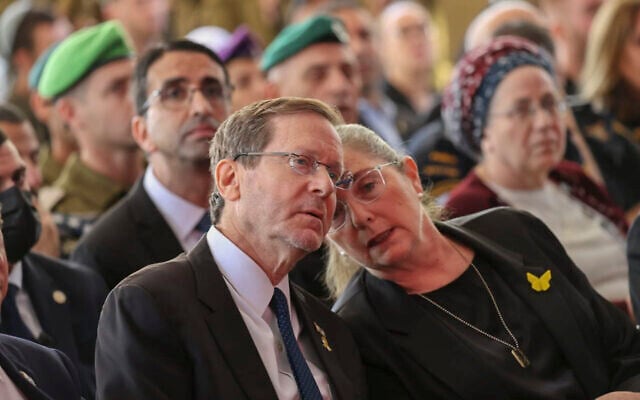 President Isaac Herzog, left, and his wife Michal attend a state ceremony marking the anniversary of the Hamas terrorist attack on October 7, at Mount Herzl military cemetery in Jerusalem, on October 16, 2025. (Alex Kolomoisky/POOL) President Isaac Herzog, left, and his wife Michal attend a state ceremony marking the anniversary of the Hamas terrorist attack on October 7, at Mount Herzl military cemetery in Jerusalem, on October 16, 2025. (Alex Kolomoisky/POOL)