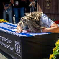 Family and friends mourn at the funeral of Uriel Baruch, in Jerusalem on October 19, 2025. (Yonatan Sindel/FLASH90)