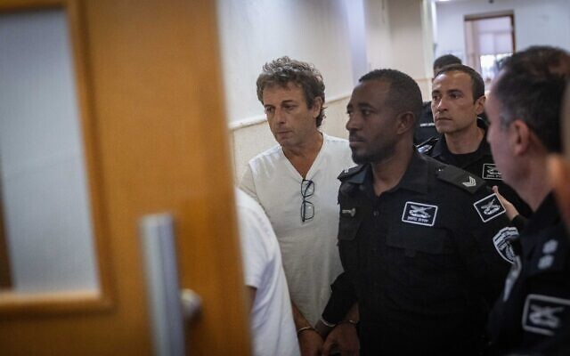 Mark Foigel, one of the activists arrested for setting fire to recycling bins and a car near the Prime Minister’s Residence, arrives at a hearing at the Jerusalem District Court on October 26, 2025. (Chaim Goldberg/Flash90)