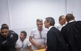 Four activists arrested for setting fire to recycling bins near the Prime Minister’s Residence arrive at a court hearing at Jerusalem District Court, October 26, 2025. (Chaim Goldberg/Flash90)