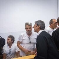 Four activists arrested for setting fire to recycling bins near the Prime Minister’s Residence arrive at a court hearing at Jerusalem District Court, October 26, 2025. (Chaim Goldberg/Flash90)