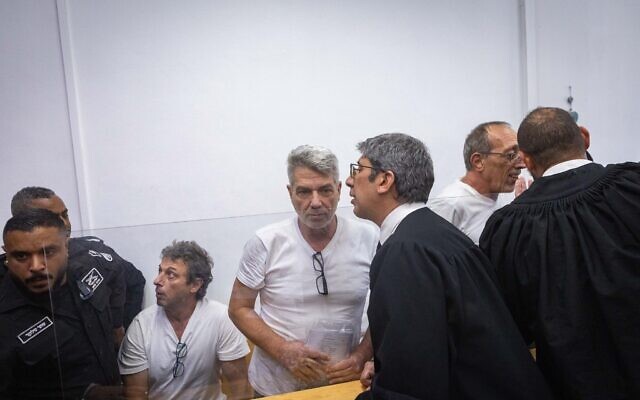 Four activists arrested for setting fire to recycling bins near the Prime Minister’s Residence arrive at a court hearing at Jerusalem District Court, October 26, 2025. (Chaim Goldberg/Flash90) Four activists arrested for setting fire to recycling bins near the Prime Minister’s Residence arrive at a court hearing at Jerusalem District Court, October 26, 2025. (Chaim Goldberg/Flash90)