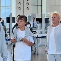 Swedish activist Greta Thunberg (c) at Ramon International Airport on October 6, 2025, before being deported along with other Gaza flotilla activists. (Foreign Ministry)