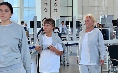 Swedish activist Greta Thunberg (c) at Ramon International Airport on October 6, 2025, before being deported along with other Gaza flotilla activists. (Foreign Ministry)