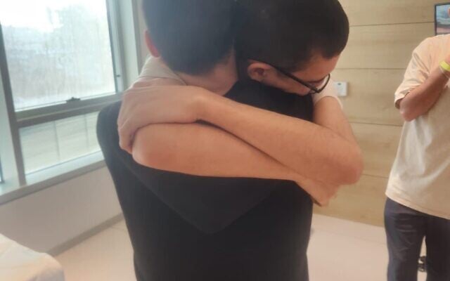 Evyatar David and Guy Gilboa-Dalal embrace at the hospital following their release from captivity on  October 13, 2025. (Government Press Office)