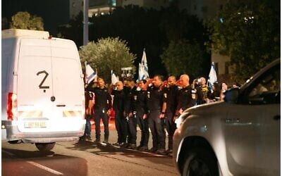 Police salute a van carrying the remains of four hostages as they are being taken for identification on October 13, 2025 (Israel Police)