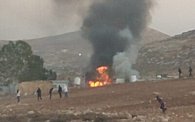 A burning home, allegedly torched by settlers, at the Bedouin community of al-Ara'ara, near Mukhmas, west of Ramallah, in the West Bank, October 25, 2025. (Courtesy/Torat Tzedek)