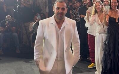 Former hostage Eli Sharabi participates in the opening night of Tel Aviv Fashion Week on October 26, 2025 (Courtesy)