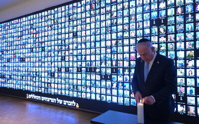 Prime Minister Benjamin Netanyahu lights a candle in memory of the victims of the war against Hamas in Gaza, next to a wall with faces of victims, at the National Library of Israel in Jerusalem, October 12, 2025. (Amos Ben Gershom/GPO) Prime Minister Benjamin Netanyahu lights a candle in memory of the victims of the war against Hamas in Gaza, next to a wall with faces of victims, at the National Library of Israel in Jerusalem, October 12, 2025. (Amos Ben Gershom/GPO)