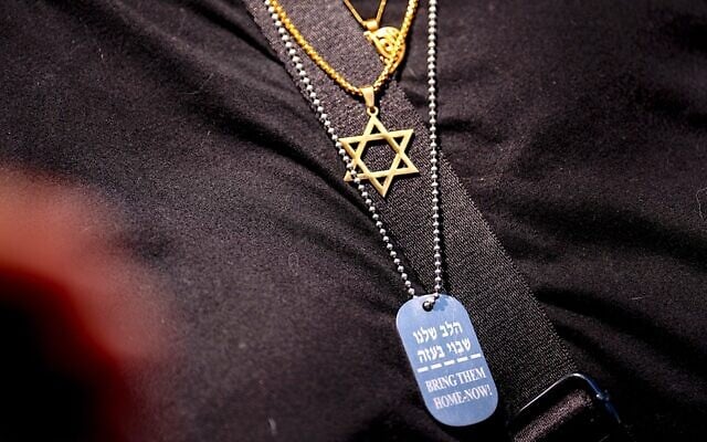 Illustrative: A woman wears a Star of David and a necklace remembering the Israeli hostages during a rally at George Washington University, May 2, 2024. (Andrew Harnik/Getty Images via JTA)