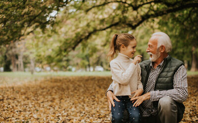 Handsome grandfather spending time with his granddaughter in park on autumn day
JCF
