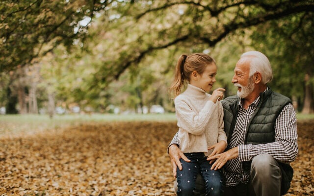 Handsome grandfather spending time with his granddaughter in park on autumn day
JCF