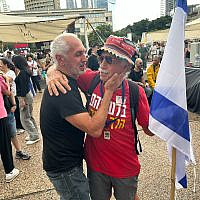 Alon Shirizly (right) and a friend celebrate news that Israel and Hamas reached a hostage deal in Gaza, Tel Aviv's Hostages Square, October 9, 2025. (Ben Sales/Times of Israel)