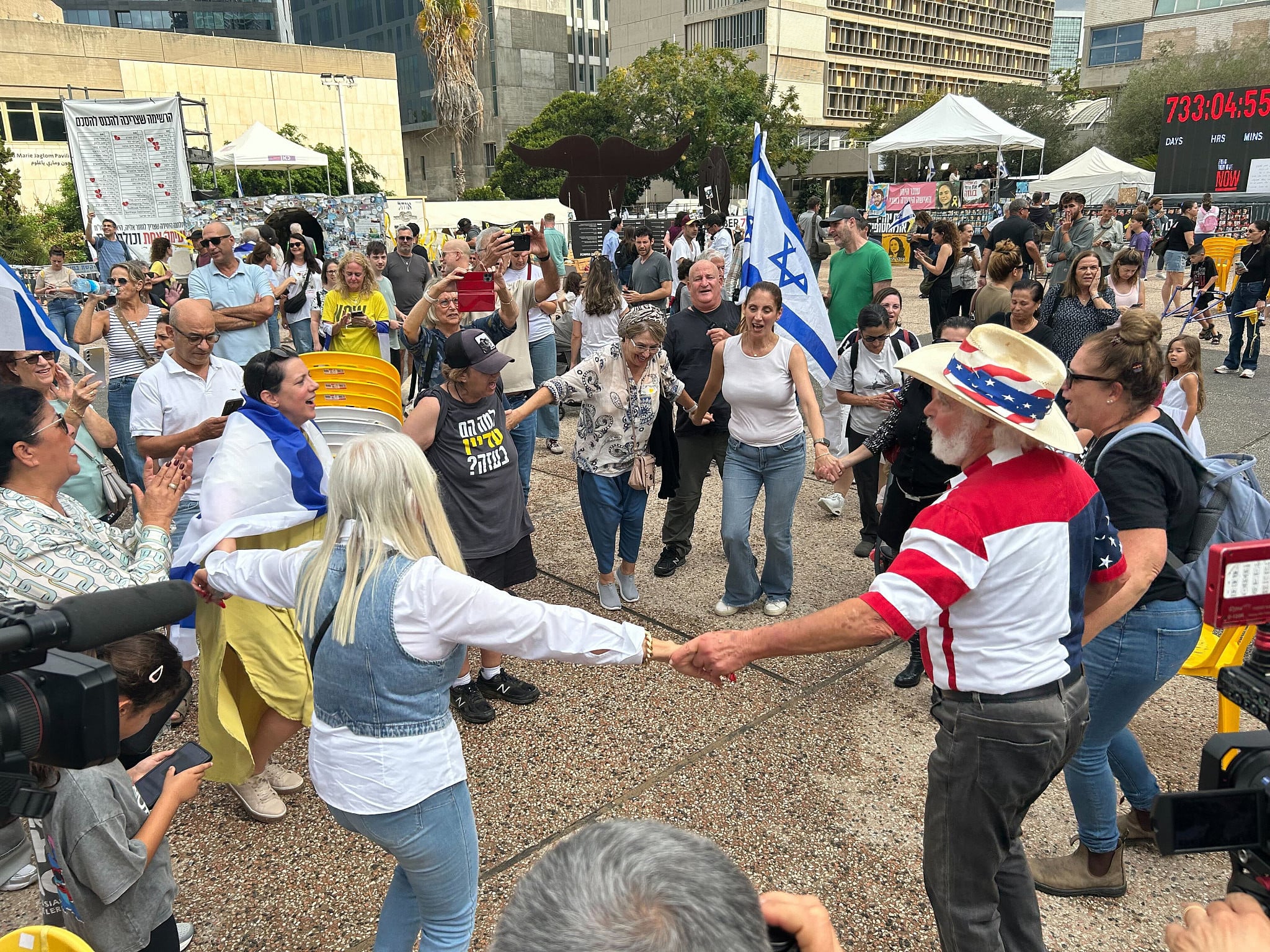 Group dances, sings songs of hope and peace at Hostages Square in Tel Aviv
